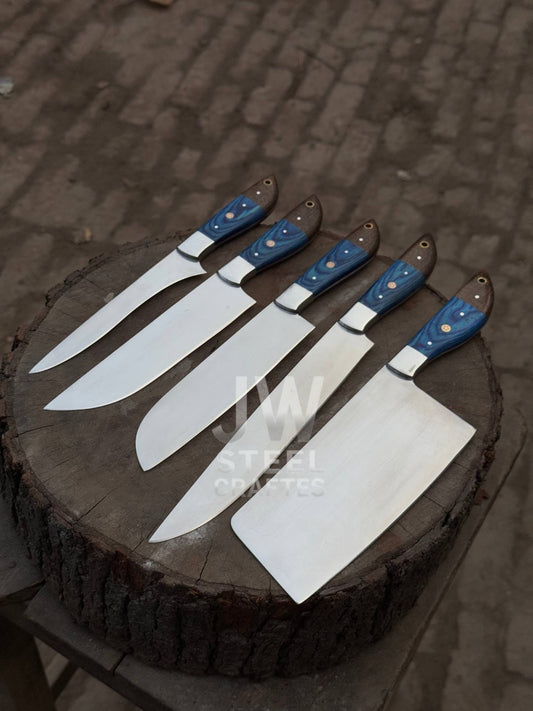Hand-forged Damascus steel chef knife set with custom blue and brown wood handles, crafted by JW SteelCrafts, displayed on wooden block.