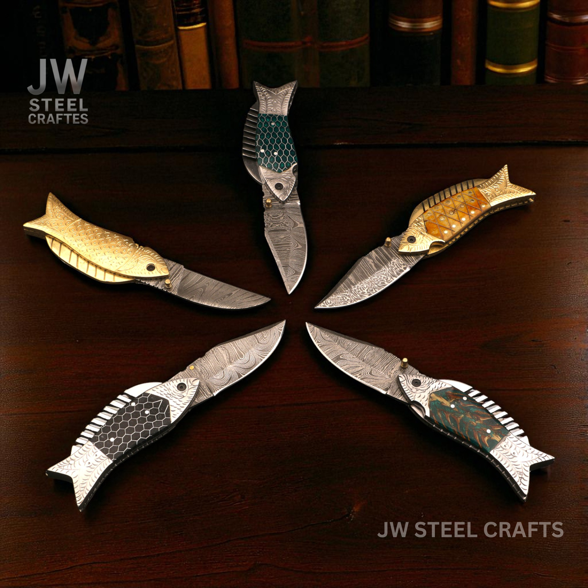 Five fish-shaped knives arranged in a circle on a wooden surface with 'JW Steel Crafts' branding.