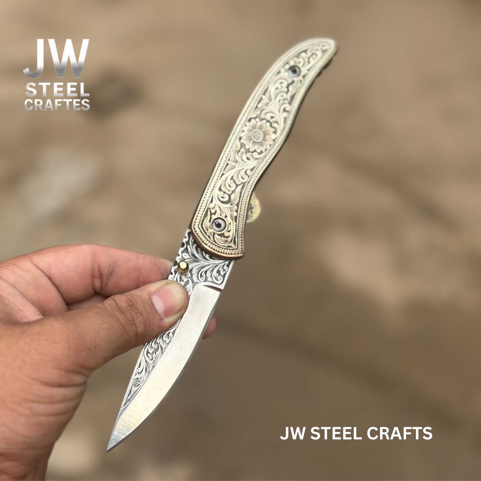 Decorative knife held by a hand with 'JW Steel Crafts' branding.