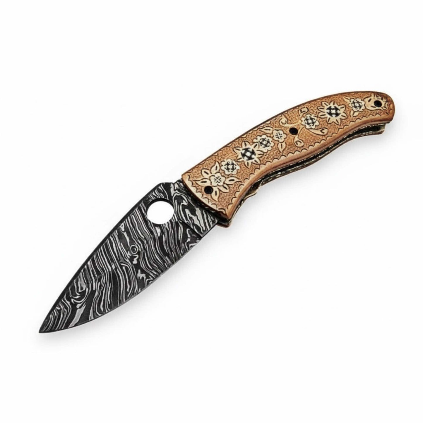 Studio-style product image of a handcrafted Damascus steel folding knife with a compact drop-point blade showing bold black-and-silver Damascus patterns, round thumb-hole opener, and an engraved floral-pattern wooden handle, isolated on a clean white background by JW SteelCrafts.