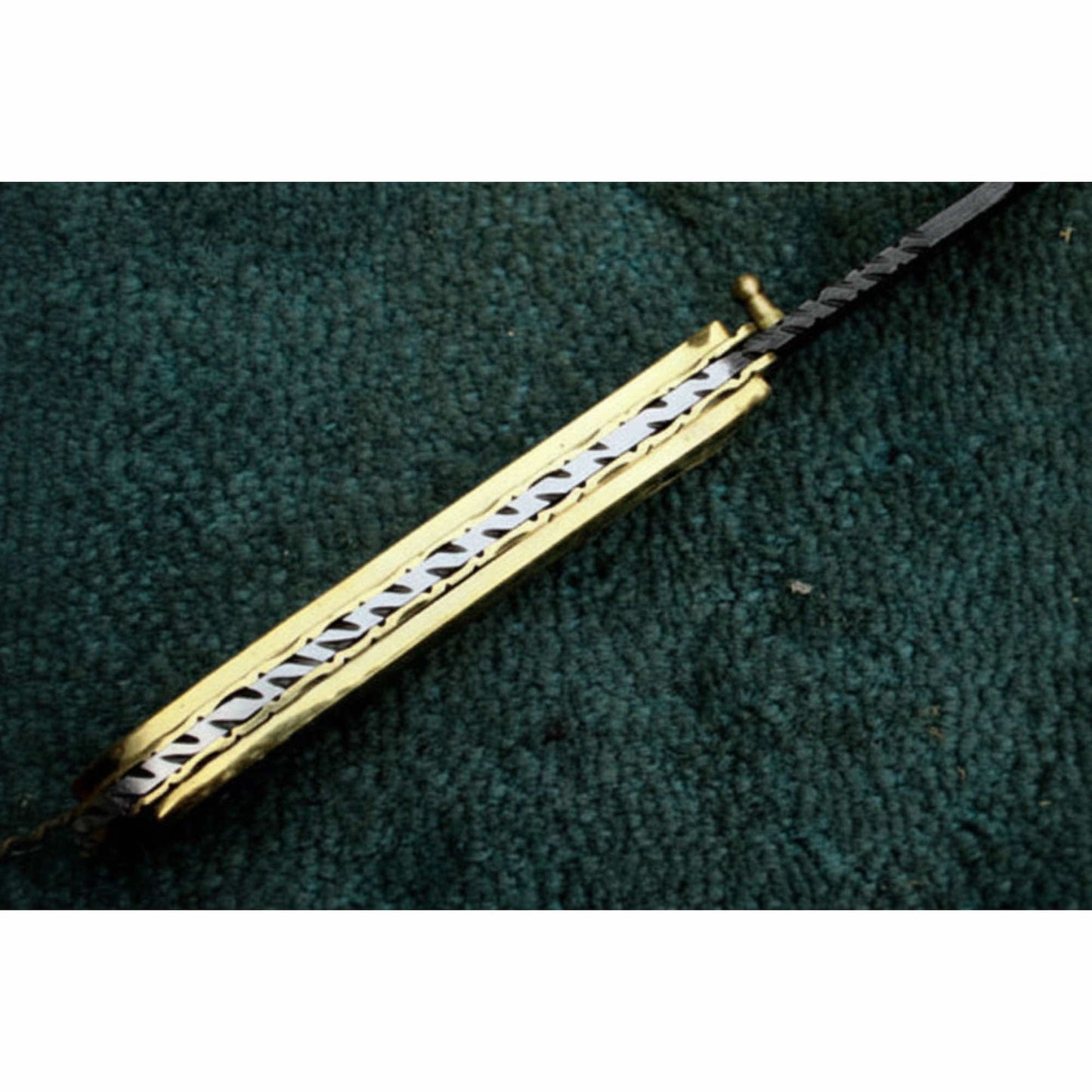 JW SteelCrafts handmade Damascus steel folding knife showing brass liner and internal spine construction detail