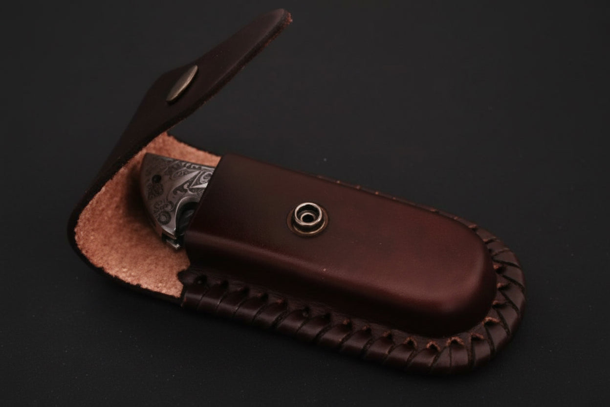 Brown leather knife sheath with a pocket knife on a dark background