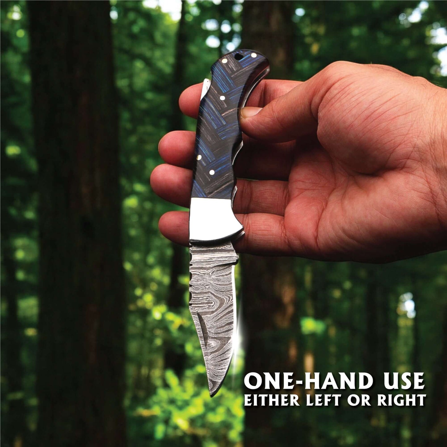 One-hand operated Damascus steel folding knife with pakka wood handle and stainless steel bolster, shown in hand for left- or right-handed use outdoors.
