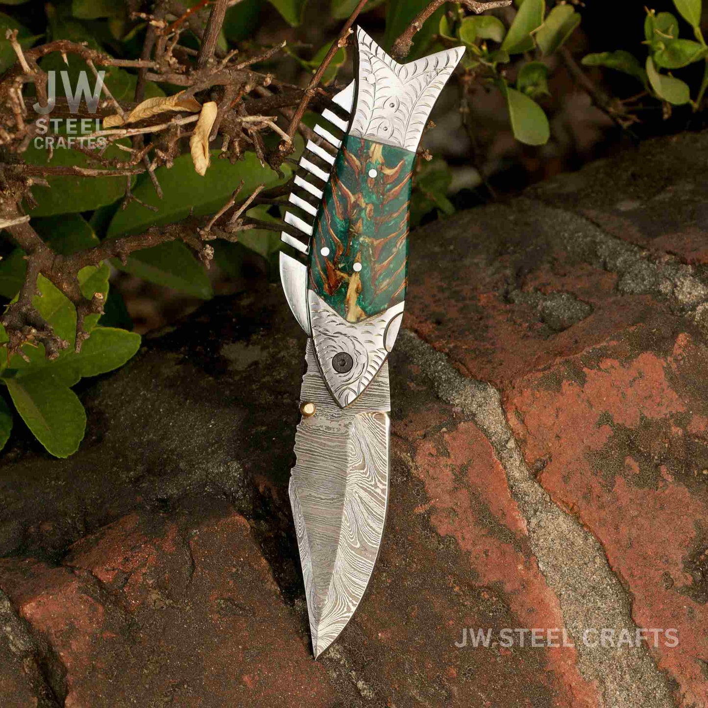 Decorative knife with artistic handle on a natural background, branded 'JW Steel Crafts'.