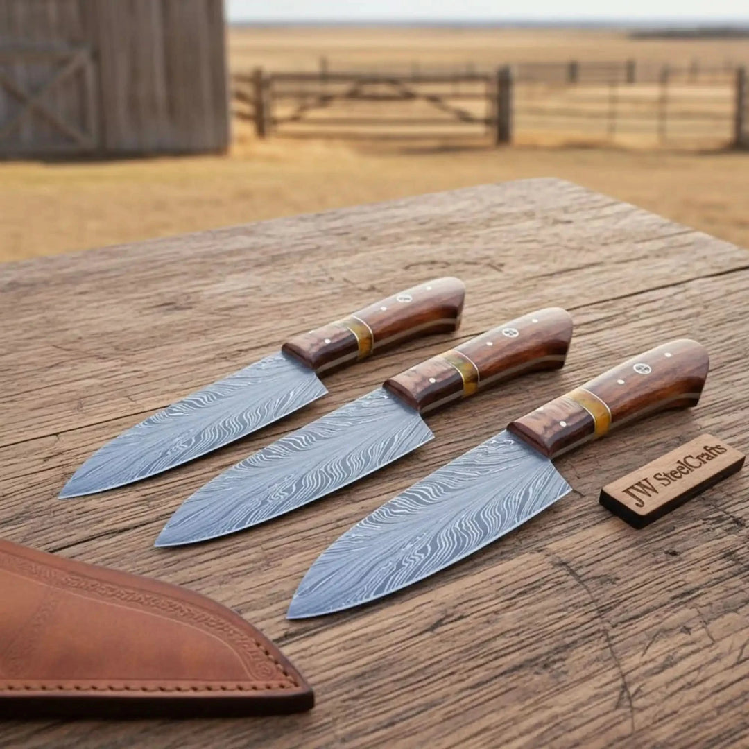 Brown wood handle Damascus chef knives displayed on rustic weathered wood in natural light.