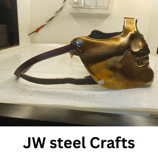Gold mask on a white surface with 'JW steel Crafts' branding.