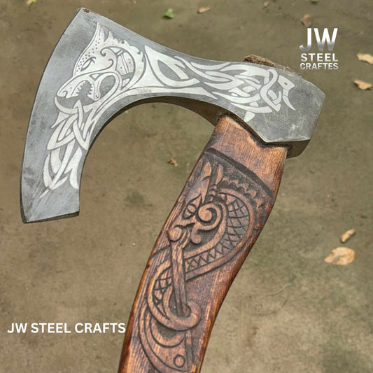 Decorative axe with engraved design on a wooden handle, branded 'JW Steel Crafts'.