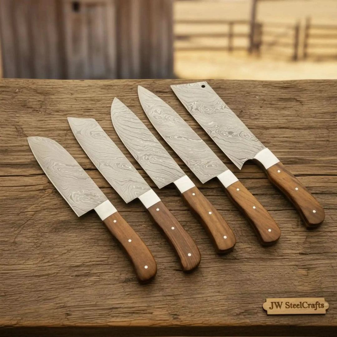 Steel Damascus kitchen knives with decorative blade detailing and ergonomic wooden handles.