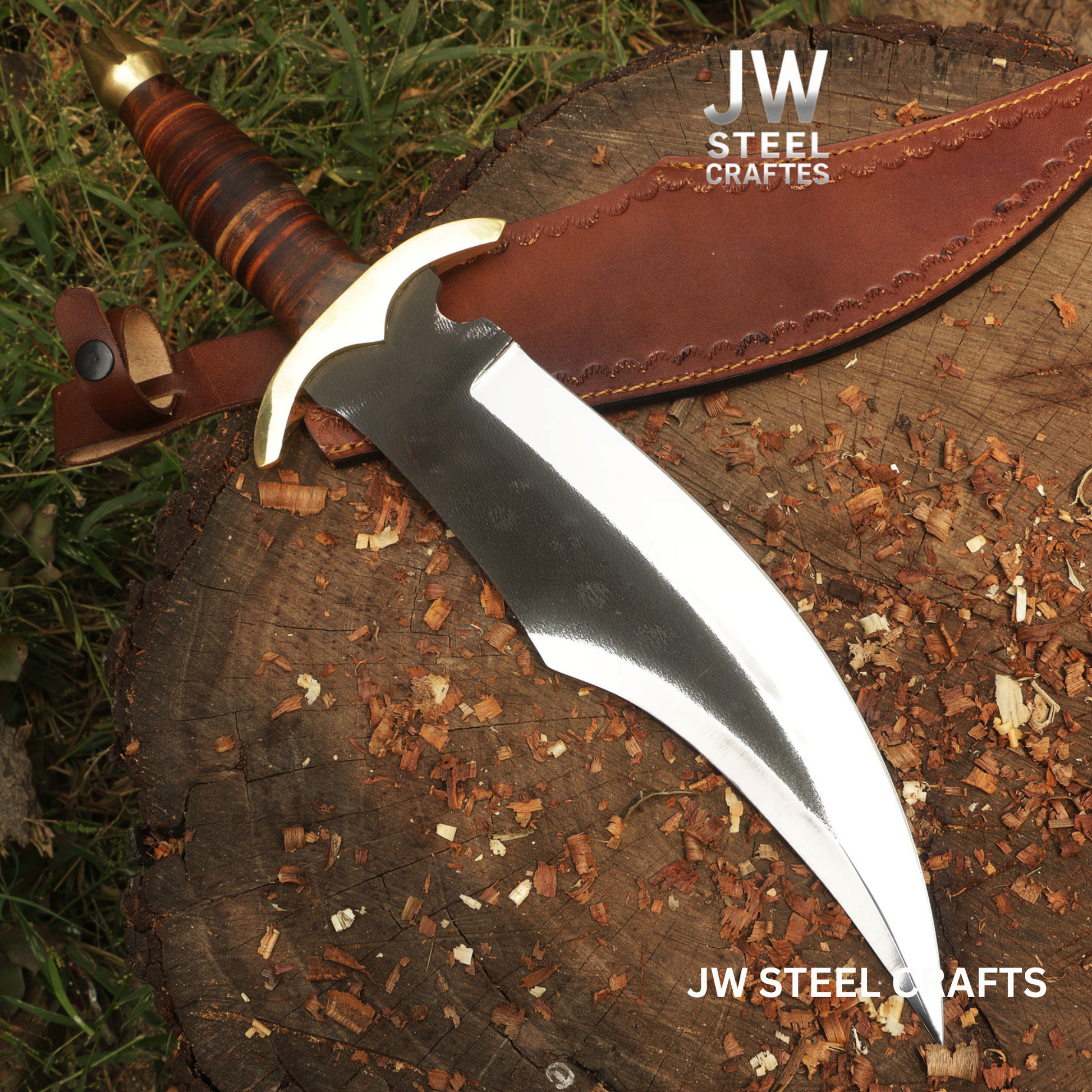 Decorative knife with a leather sheath on a wooden surface, branded 'JW Steel Crafts'.