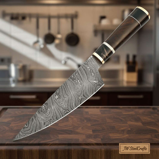 JW SteelCrafts handmade Damascus chef knife with wood handle and metal bolster on cutting board in kitchen.