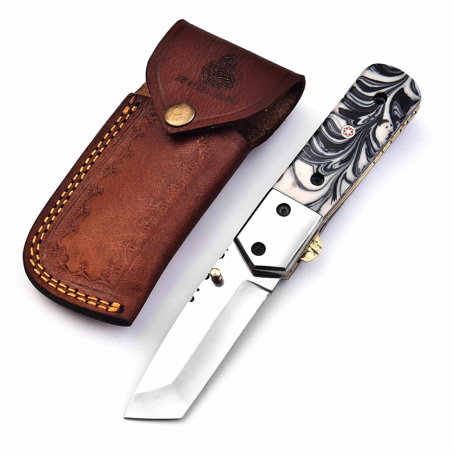 Stainless steel folding knife with marble resin handle and liner lock, displayed open beside handcrafted leather sheath