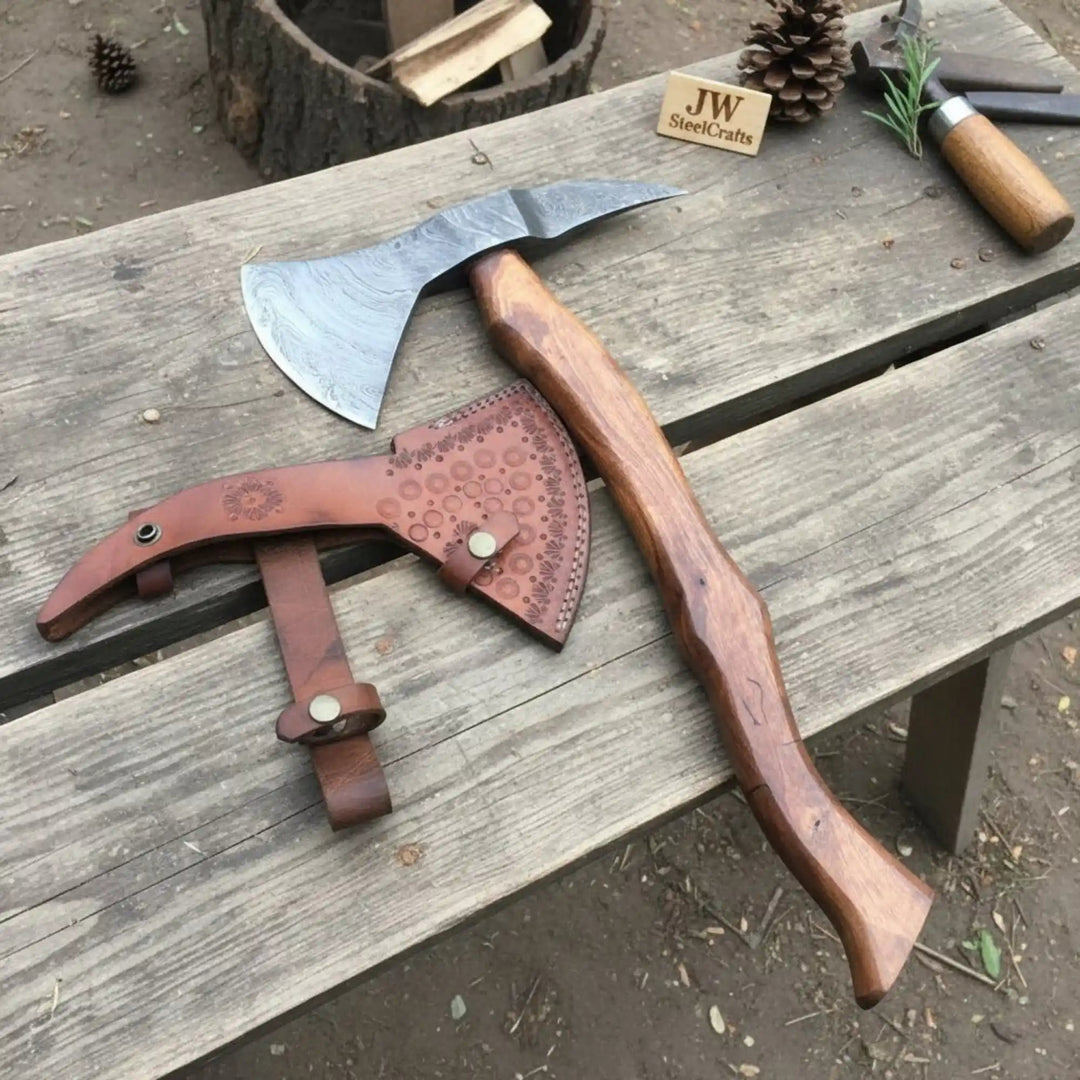     Blazewood handcrafted camping axe embedded in a tree stump with ornate Damascus detailing and rustic outdoor ambiance.
