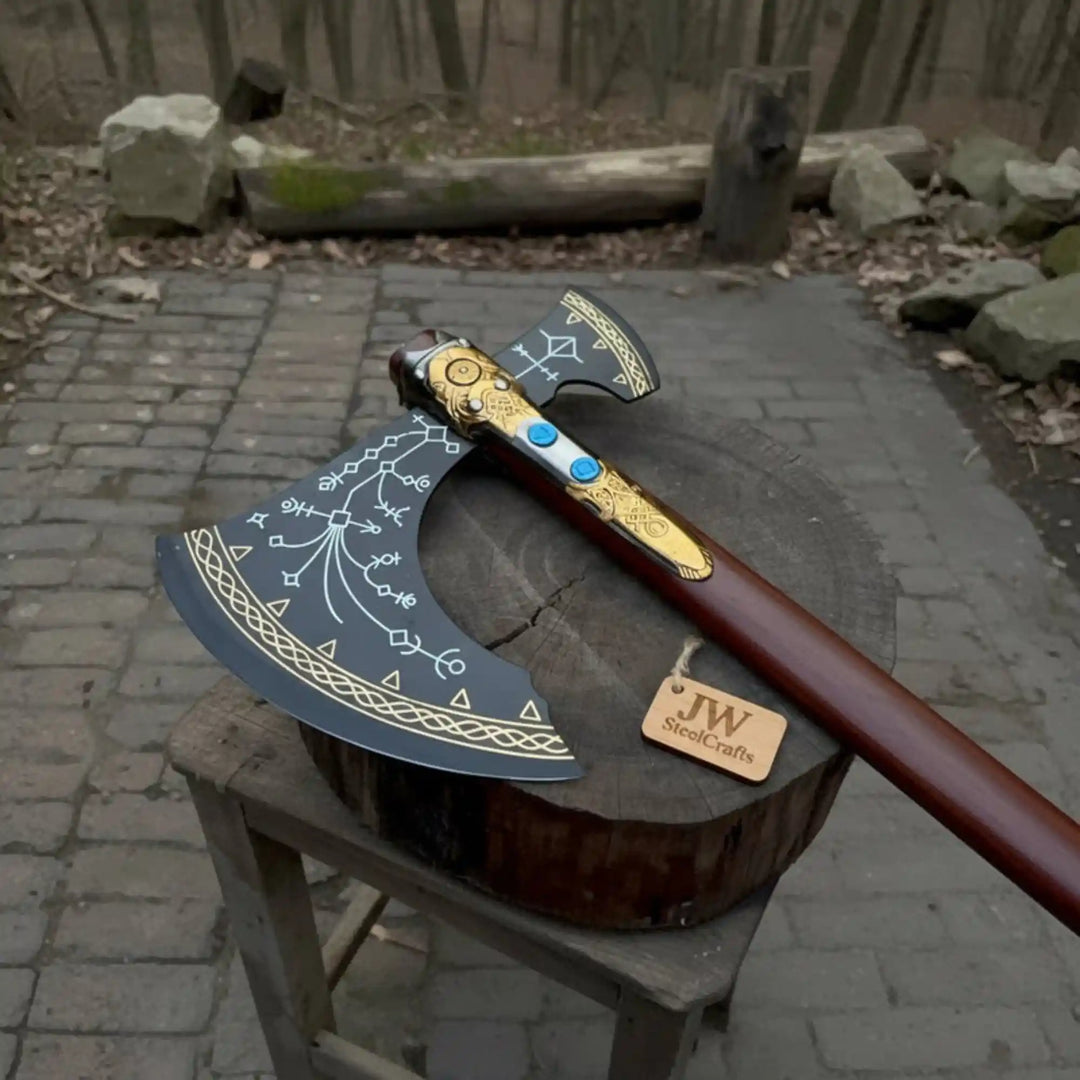 
Closeup of gold ornate handle fittings and blue gemstone inlays on JW SteelCrafts Norse fantasy display axe
