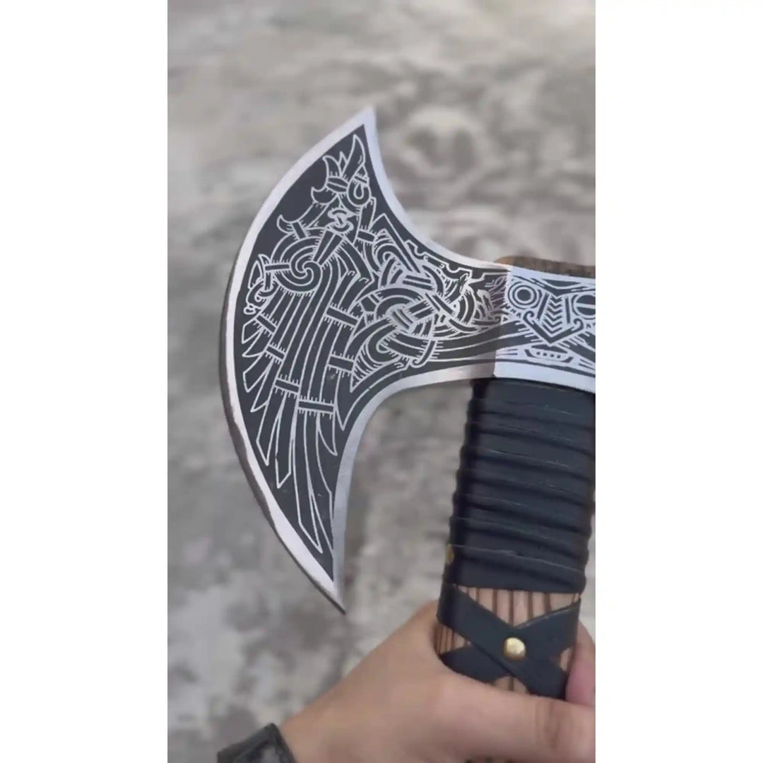 Closeup of hand engraved Nordic knotwork and rune detailing on double headed Viking decorative axe steel head