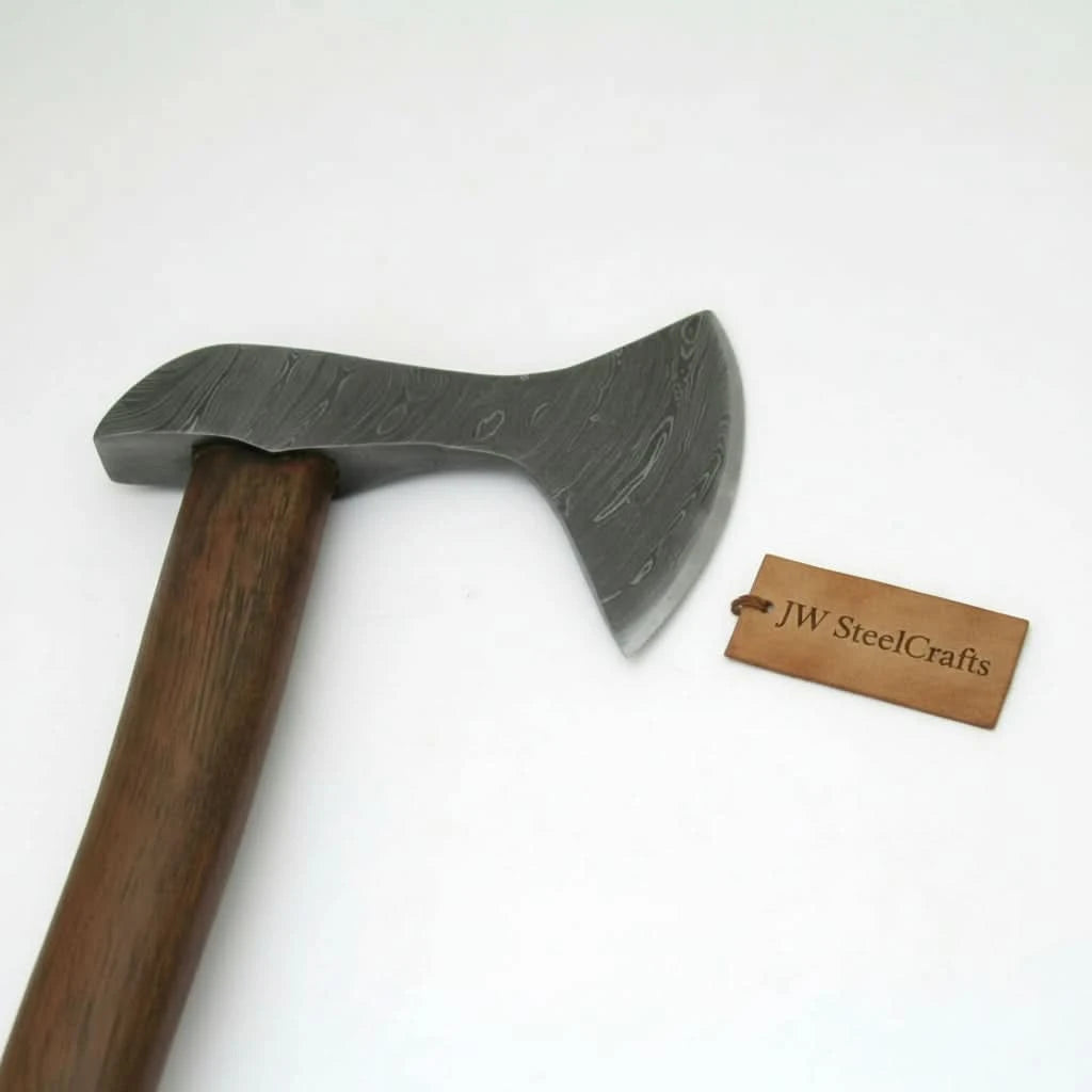     Driftwood artisan forest camp hatchet resting beside stitched leather cover in a misty woodland setting.