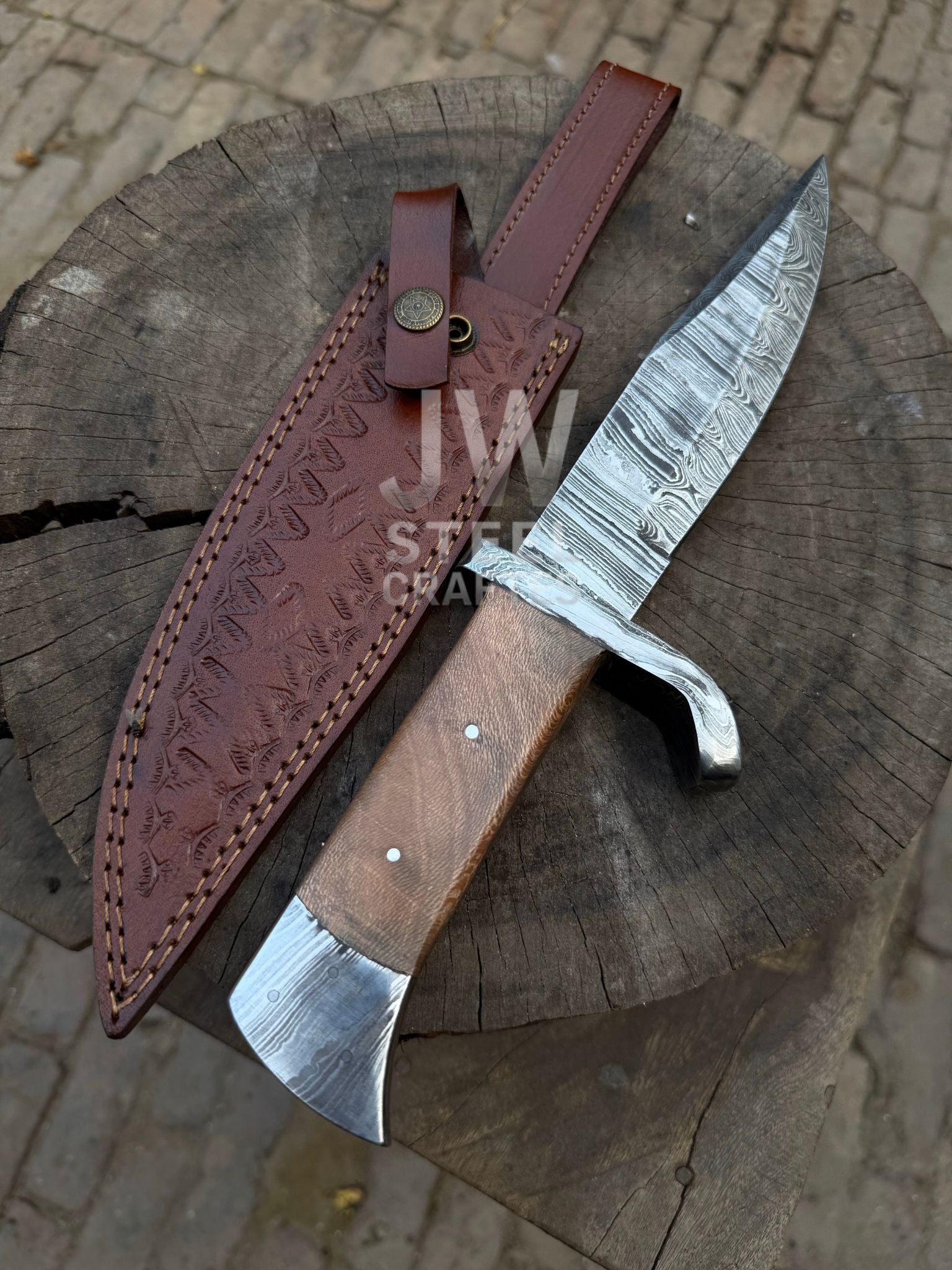 Hand-forged Damascus hunting knife with wooden handle and custom leather sheath

