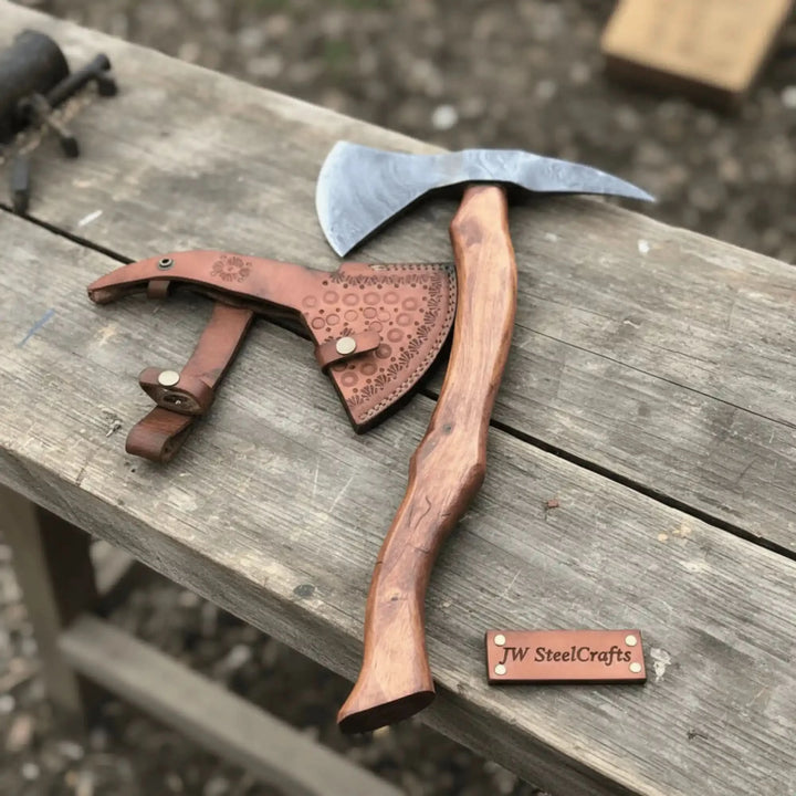     Emberwolf custom bushcraft axe resting on weathered timber with handcrafted Damascus steel and warm campfire glow.