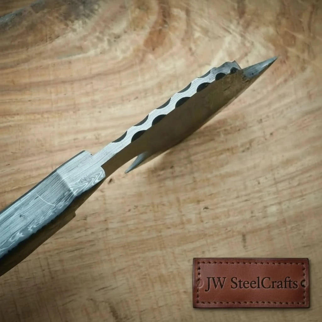     Ironvale premium Damascus camping blade with etched steel wave patterns and ergonomic grip displayed in an outdoor environment.