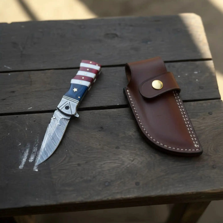 Damascus Folding Pocket Knife — American Flag Handle, Damascus Bolster, Linear Lock &amp; Hand Engraved Leather Sheath