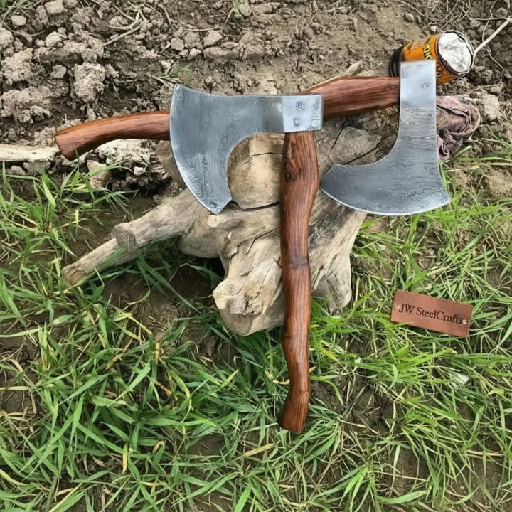     Handcrafted survival axe with razor sharp Damascus steel edge and artisan wood handle positioned naturally on a rustic outdoor tree stump.