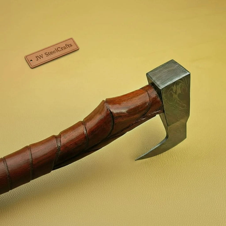     Luxury handcrafted hatchet with polished Damascus blade and custom leather sheath.