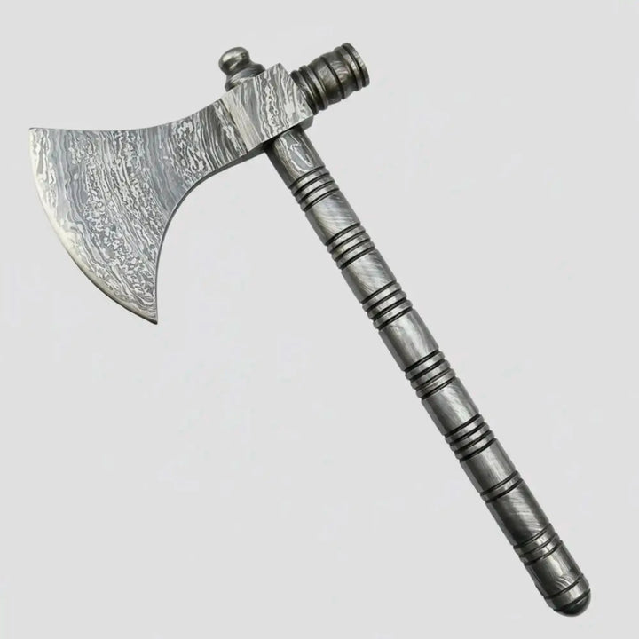     Luxury Damascus forged wilderness hand axe with artistic layered steel blade, textured grip handle, and premium handmade construction displayed among forest rocks and timber