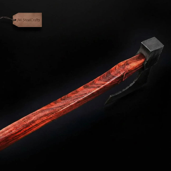     Forged woodland hatchet crafted with artisan Damascus steel blade and elegant wooden grip resting naturally among rugged stones and forest timber