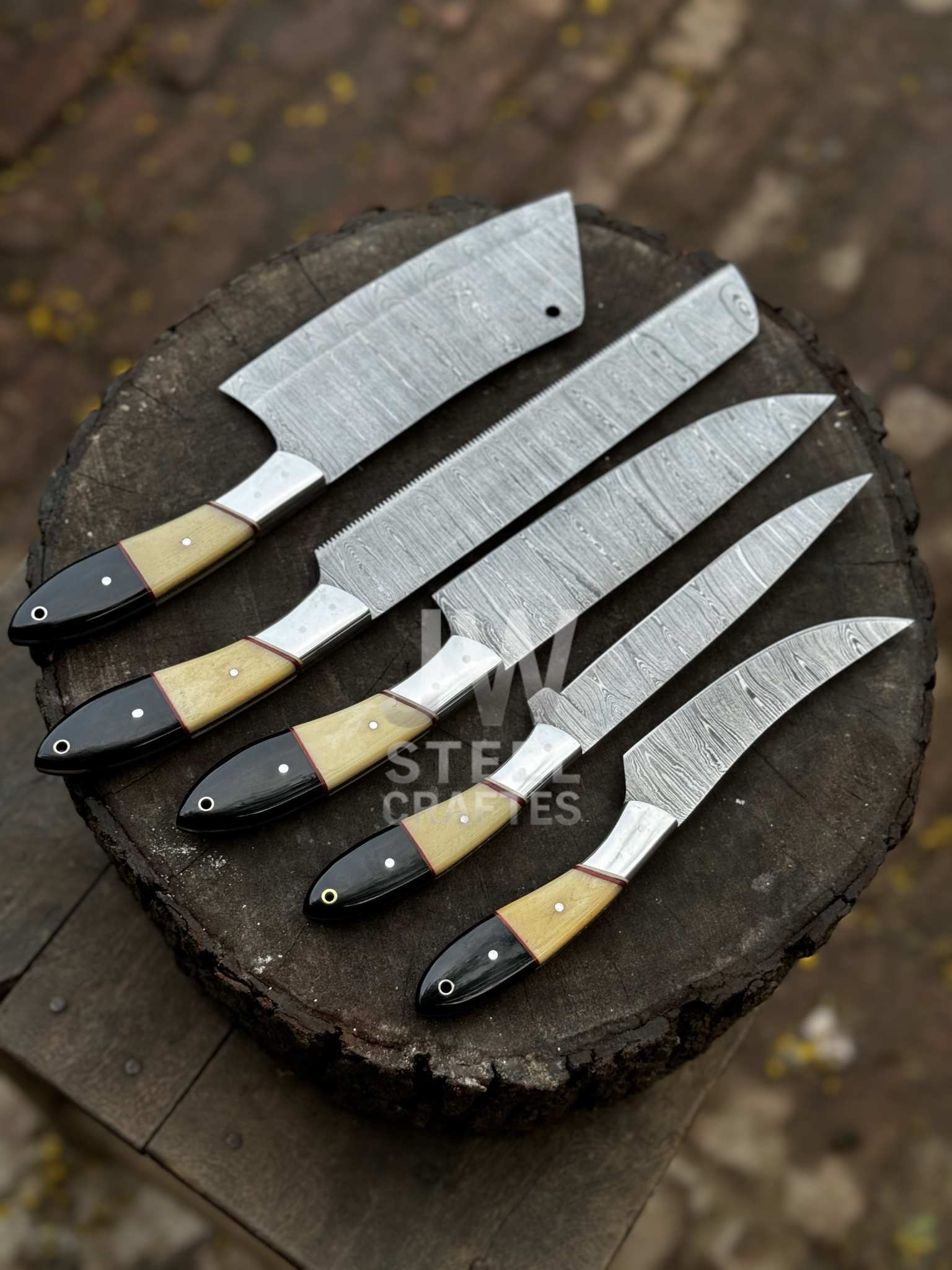Set of five knives with wooden handles on a wooden surface