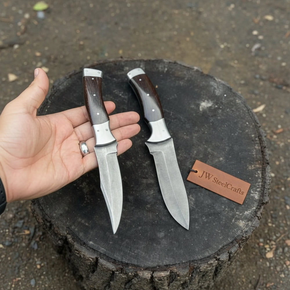 Handcrafted steel knife with ergonomic rosewood handle shown in outdoor setting