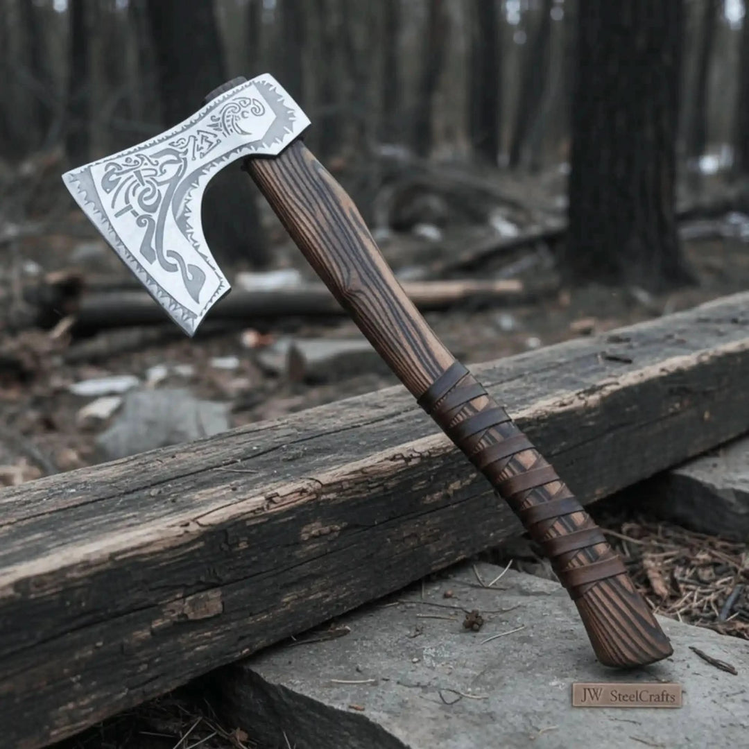 Hand forged carbon steel Viking axe with carved ash wood handle and leather wrap grip on white background
