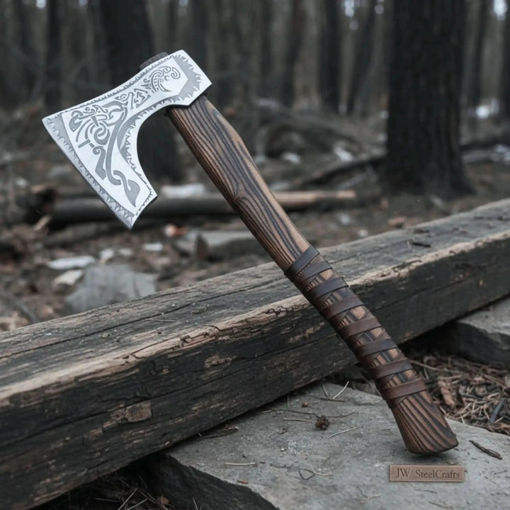 Hand forged carbon steel Viking axe with carved ash wood handle and leather wrap grip on white background