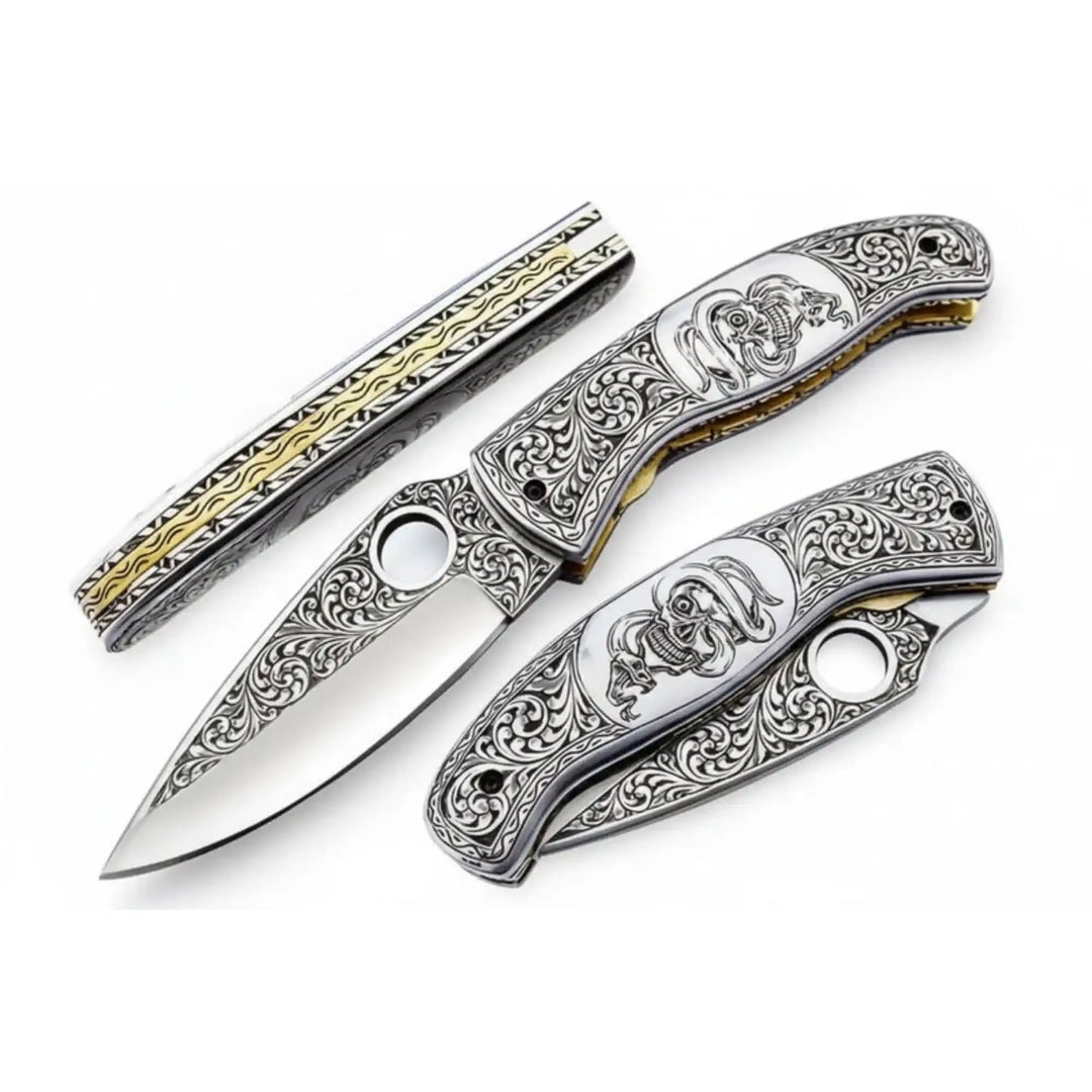     Artistic metal scrollwork folding pocket knife with decorative engraving and polished blade finish
