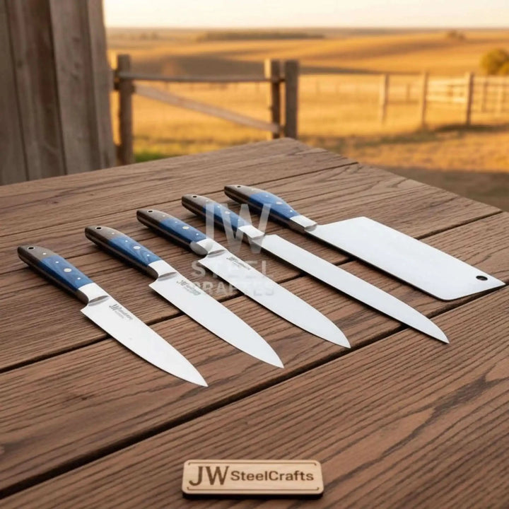 Artisan Damascus cooking knives displayed on rustic wooden surface outdoors