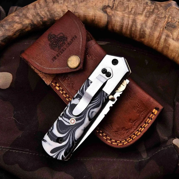     Durable collector folding knife paired with stitched leather case and stylish resin scales