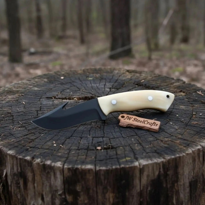Rustic camping gut hook knife with bone handle, dark blade, brown leather sheath