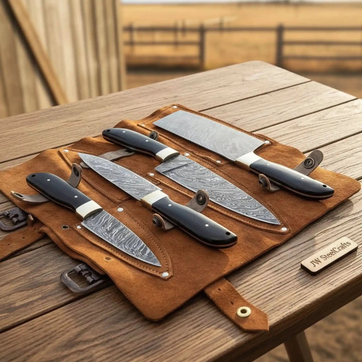 Damascus kitchen cutlery set featuring sharp patterned blades and leather storage roll.