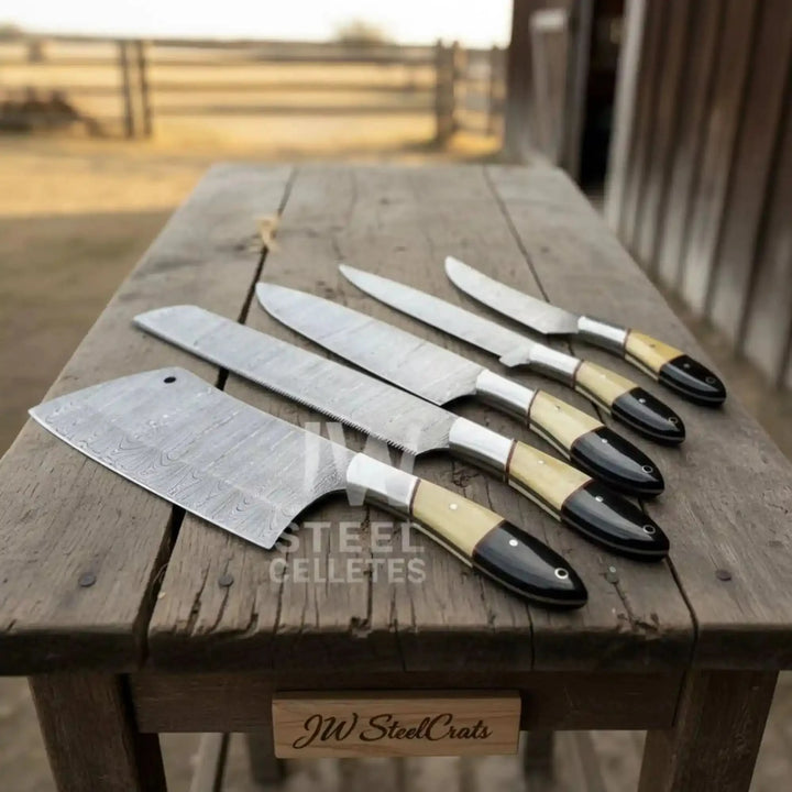 A luxury 5-piece handmade Damascus steel chef knife set featuring unique camel bone and black micarta hybrid handles, displayed on a rustic wooden log in an outdoor setting.