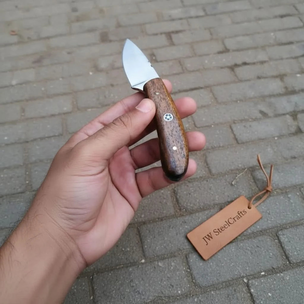 Outdoor camping knife with wood handle, smooth steel blade, decorative pin, and JW SteelCrafts tag beside it.