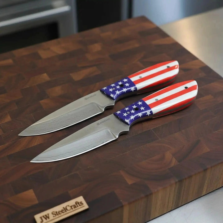 Carbon Steel Drop Point Skinner Knives Set Two Knives With American Flag Handles On A Wooden Cutting Board
