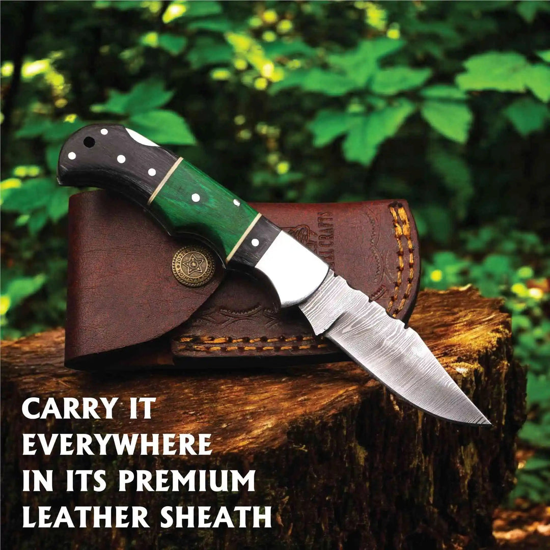     Mossycreek Damascus EDC knife with wooden handle and compact leather sheath displayed on rustic timber stump