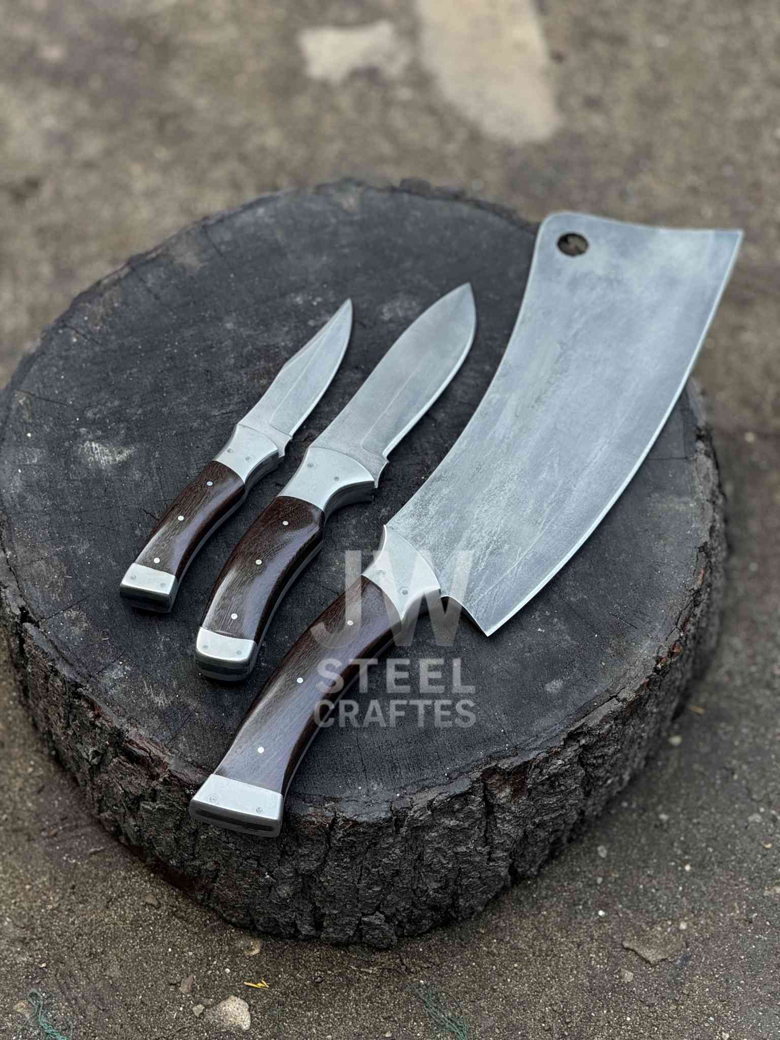 Three knives on a wooden block with 'Steel Craftes' branding.