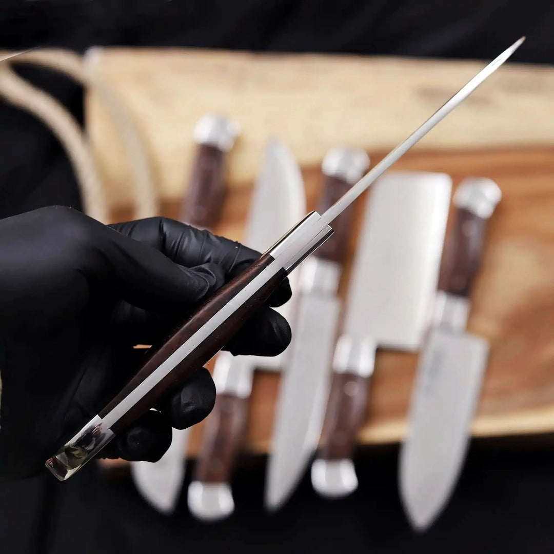 Side view of a professional chef knife showing full tang blade and ergonomic handle design.