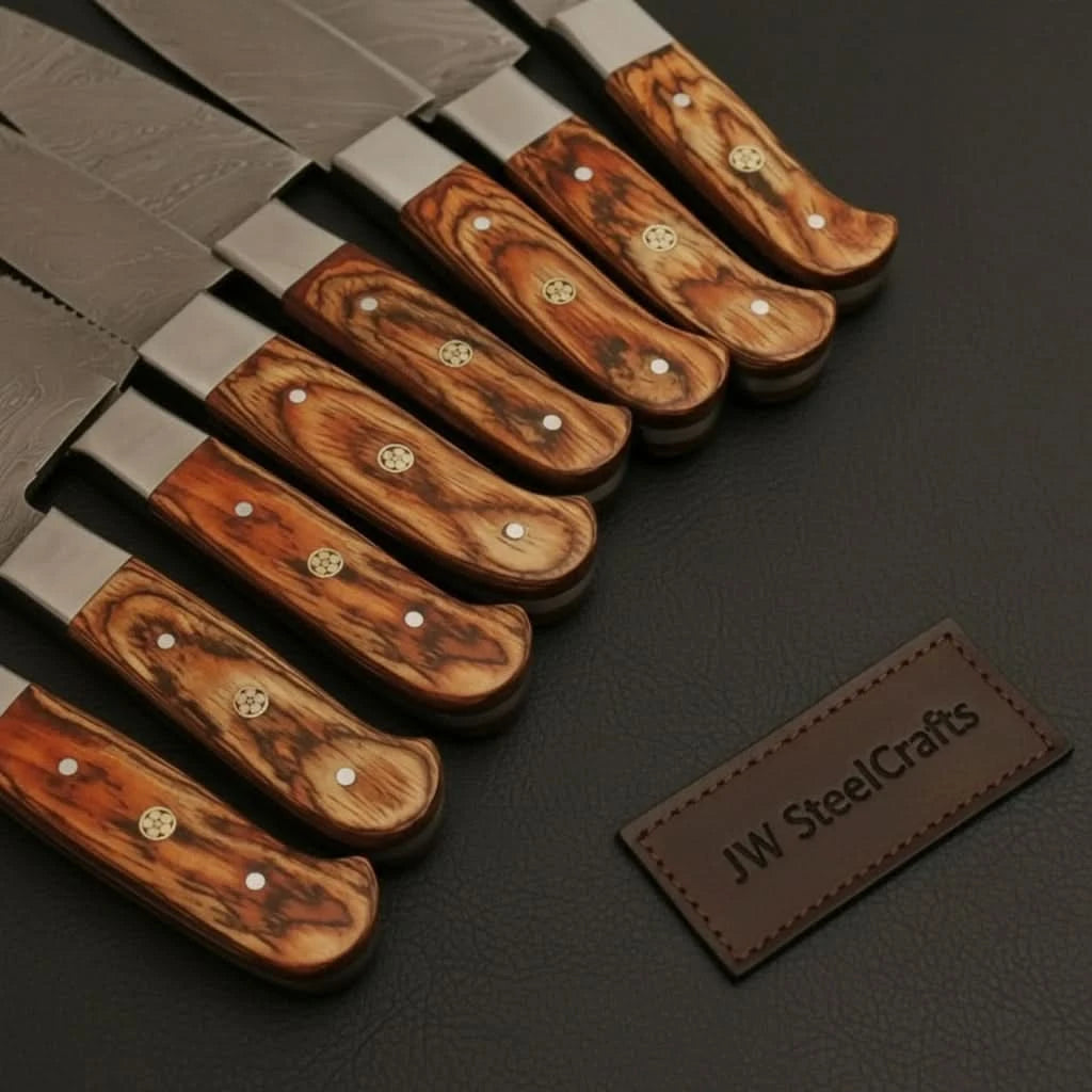 Decorative woodgrain handle Damascus collection featuring rich reddish brown patterns and brass mosaic accents.