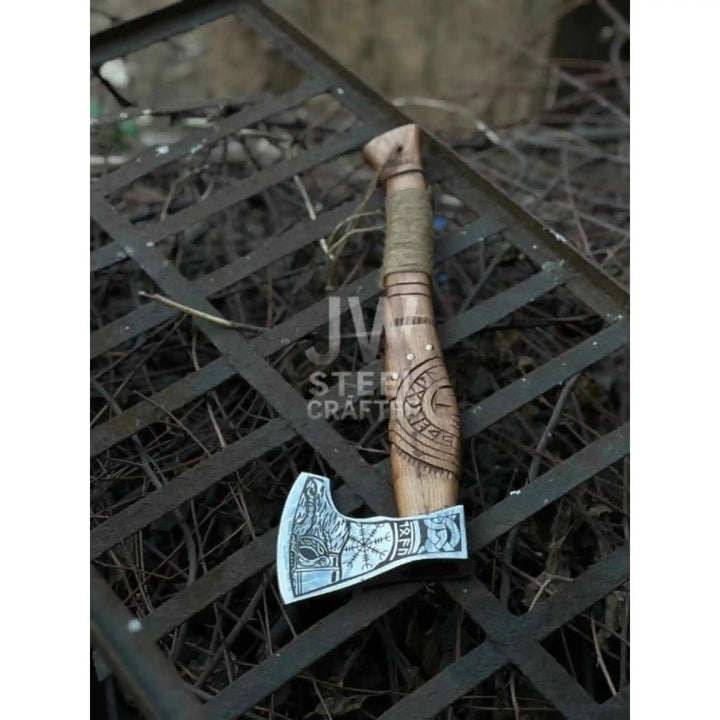 
Closeup of precision engraved Norse rune pattern on Viking bearded axe steel head

