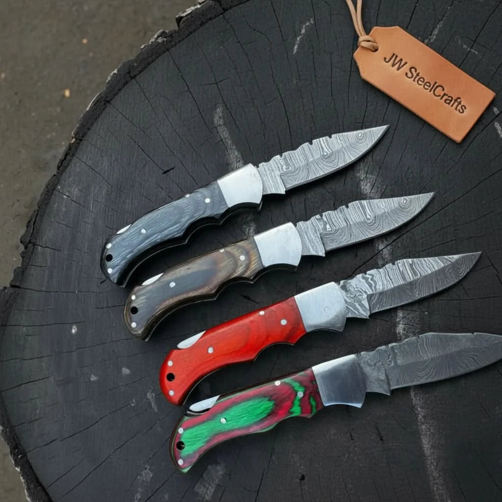 Custom pocket knife set with Damascus pattern blades, ergonomic handles, metal pins, and polished bolsters.