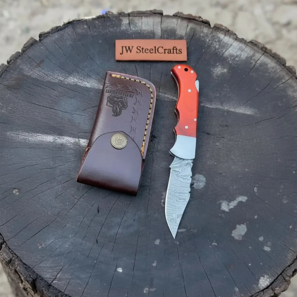Lockback Damascus knives with multicolor handles, sharp patterned blades, and rustic dark tree stump background.