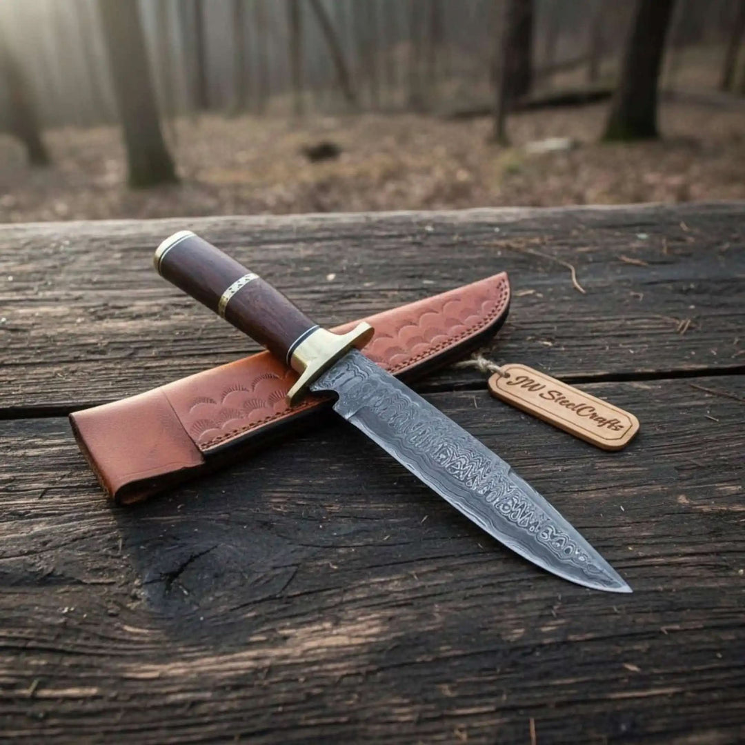     Mini Damascus fixed blade knife with slim wooden handle and brown leather sheath outdoors