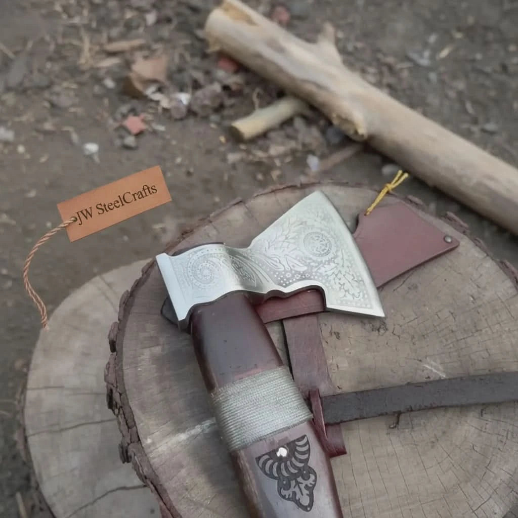 Blackveil-themed Norse battle hatchet featuring decorative Nordic engravings and handcrafted leather sheath outdoors.