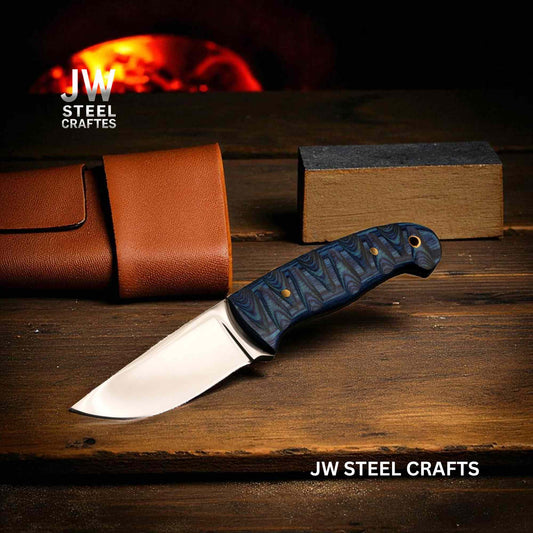 Forked knife with blue handle on a wooden surface, JW Steel Crafts branding visible