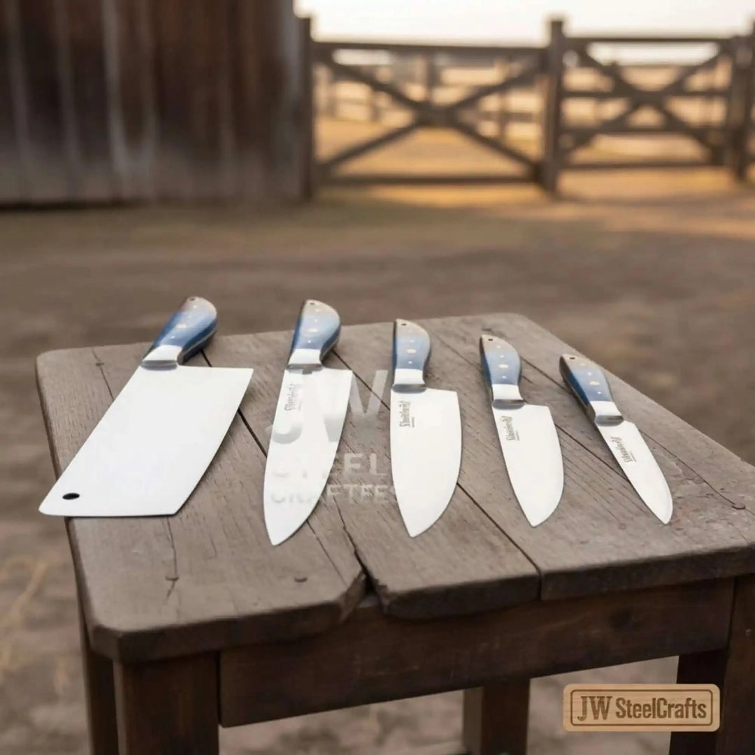 Blue wood Damascus chef knife set with 5 handmade kitchen knives displayed on rustic wooden stool